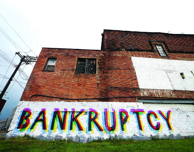 Colorful graffiti on a wall in Detroit that says "bankruptcy"
