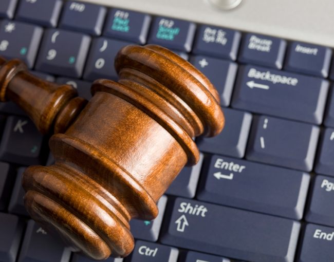 A gavel resting on a computer keyboard