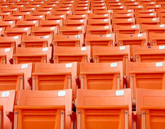 Rows of orange sports stadium seats