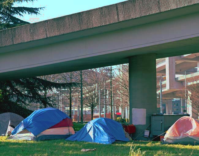Tents below a highway ramp