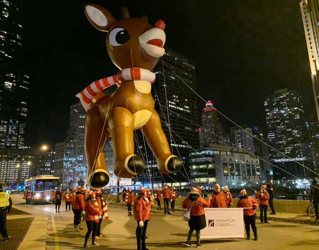 Thompson Coburn holding Rudolph parade balloon in downtown Chicago